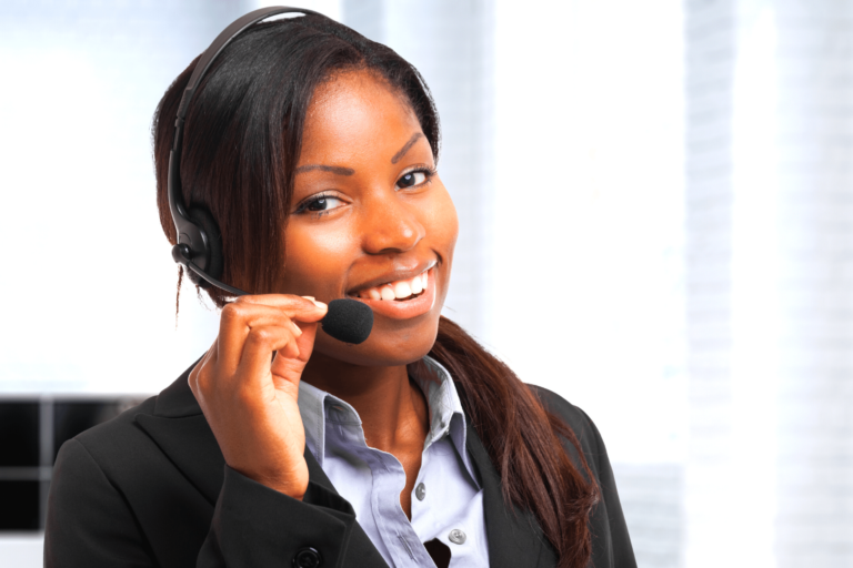 A black woman on the phone in a call center.