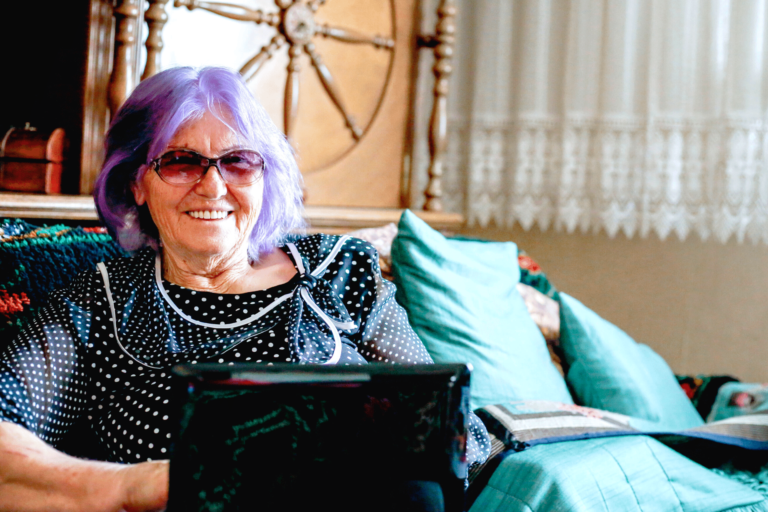 Elder woman using a laptop at home.