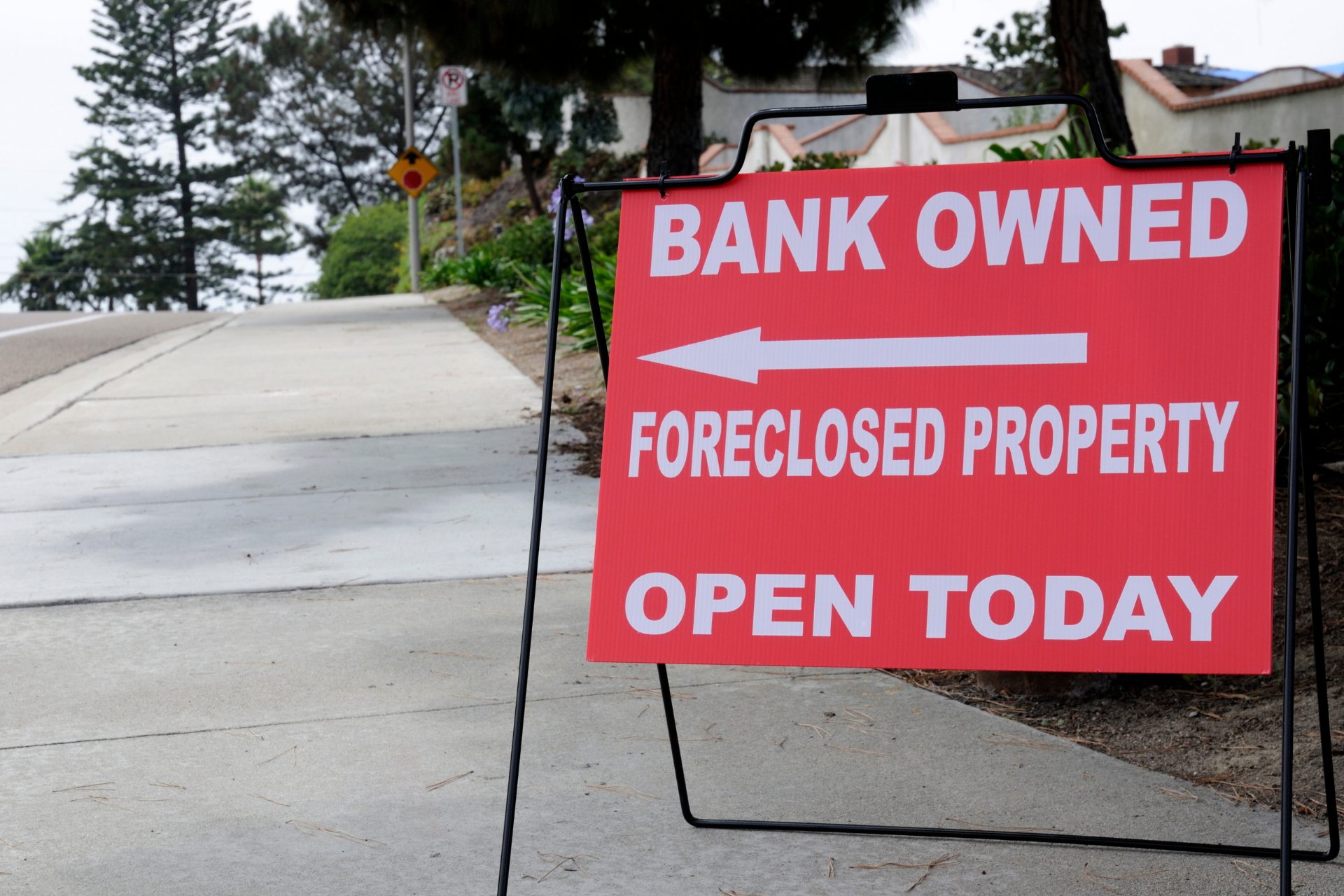 Red sign reading "Foreclosed Property"