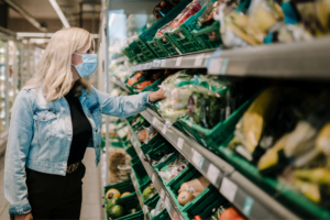 Person wearing mask shops for groceries