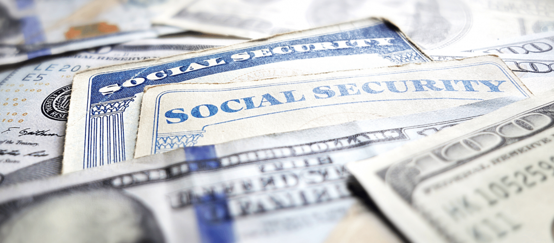 Image of $100 dollar bills and social security cards.