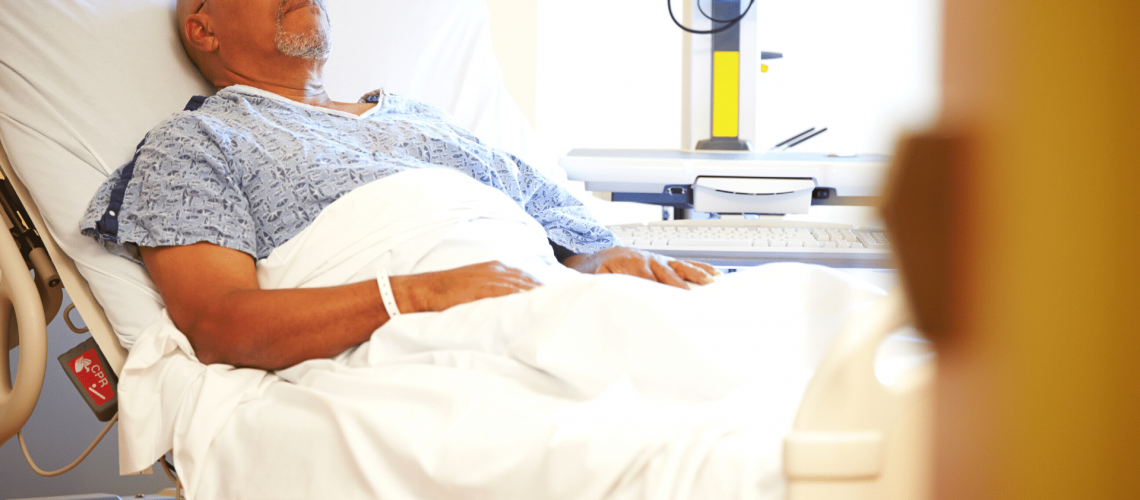 An elderly man in a hospital bed.