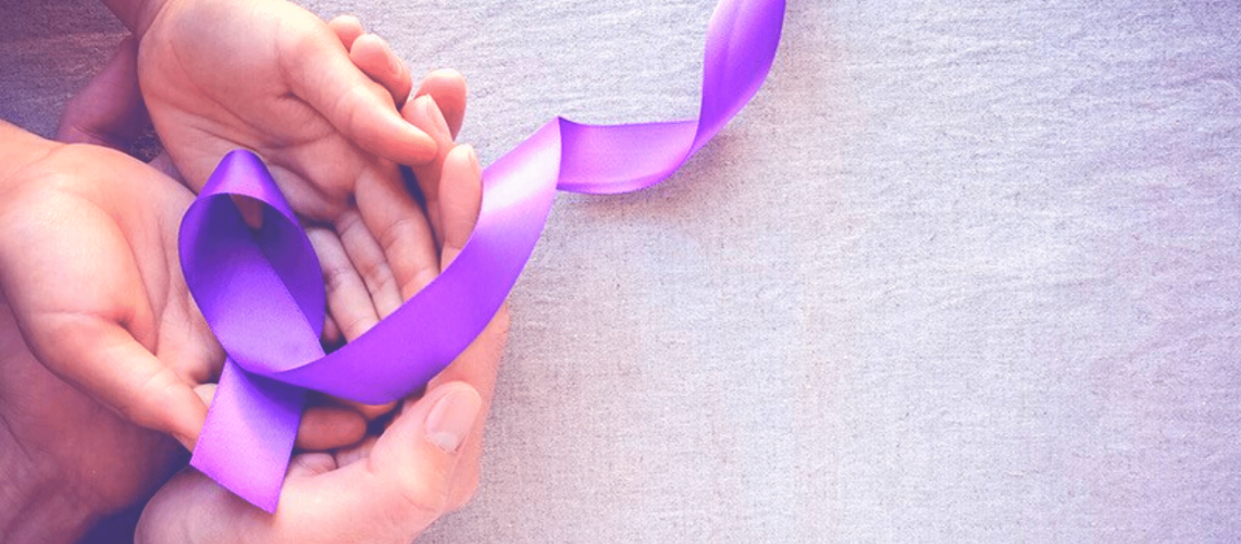 Hands holding a purple ribbon.